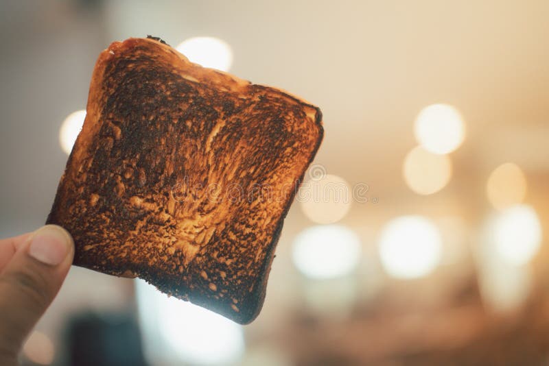 man-holding-burnt-toast-bread-slice-close-up-193862906.jpg